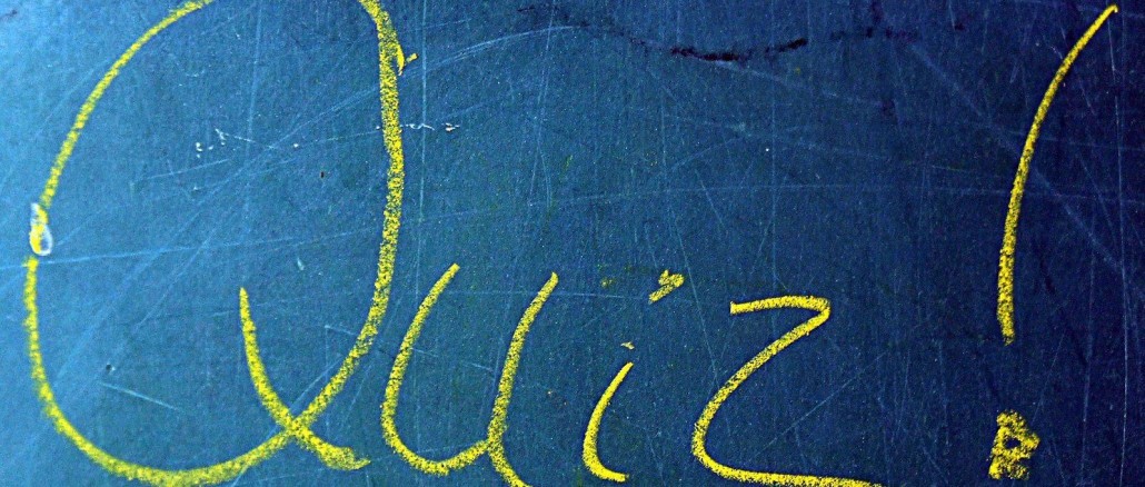 "Quiz!" written on a chalkboard with yellow ink